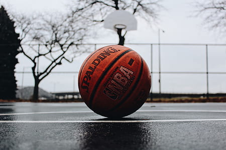 brown Spalding basketball on the ground thumbnail