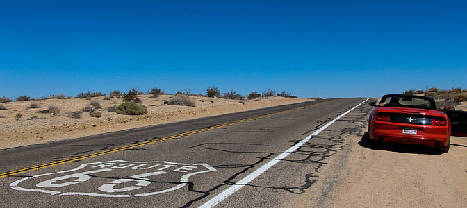 red Ford Mustang convertible coupe stopped beside road on Route 66 during daytime thumbnail
