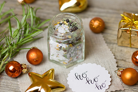 clear glass jar and orange and gold ornaments thumbnail