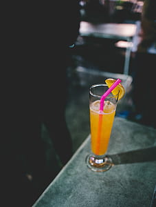 orange juice inside clear drinking glass thumbnail