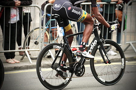 man riding on black and white road bicycle thumbnail
