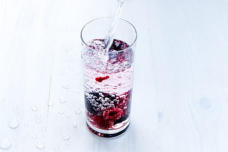 Close-up of Water Splashing in Glass Against White Background thumbnail