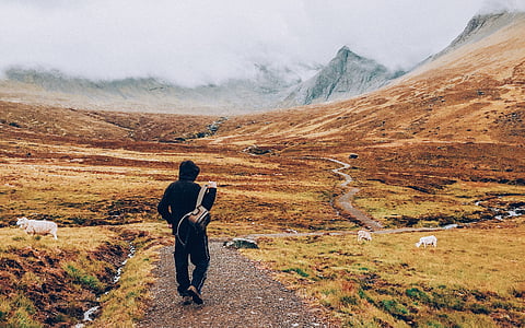 photo of person carrying bag during daytime thumbnail