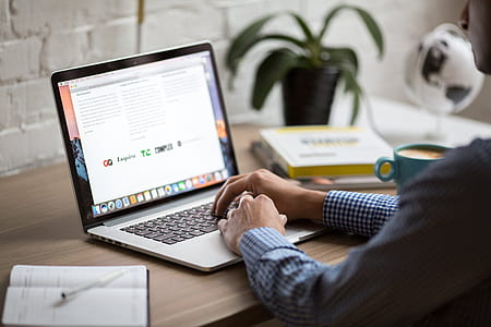 person in front of laptop on table thumbnail