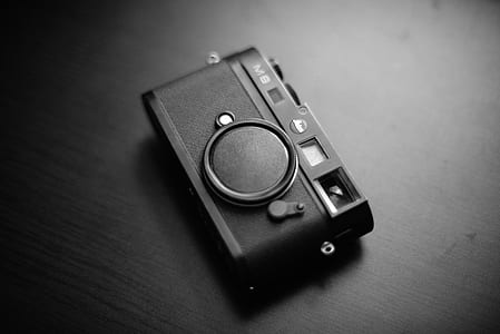 grayscale photography of camera on top of furniture thumbnail