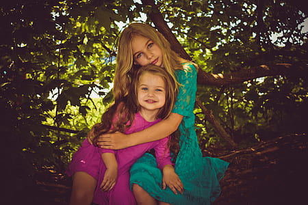 woman hugged the girl sitting on tree thumbnail