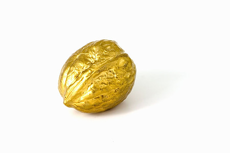 gold-color nut on white surface thumbnail