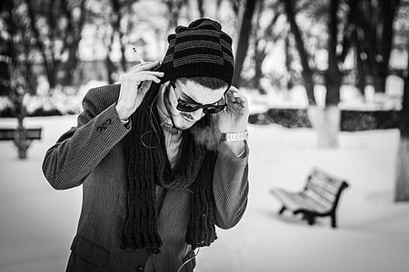 man wearing knit cap and sunglasses walking during winter thumbnail