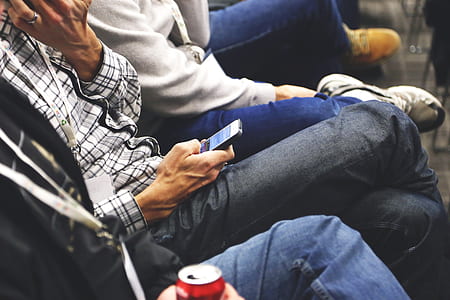 person holding smartphone sitting on chair thumbnail