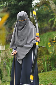 person holding black and yellow compound bow thumbnail