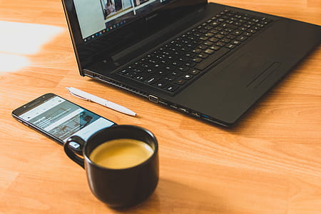 Black Laptop Computer and Black Ceramic Tea Cup thumbnail