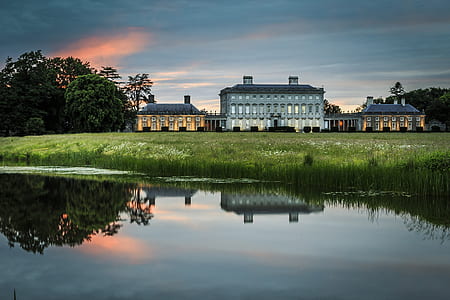 landscape photography of three houses under blue sky thumbnail