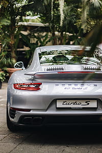 gray Porsche 911 Turbo S parked near green trees thumbnail