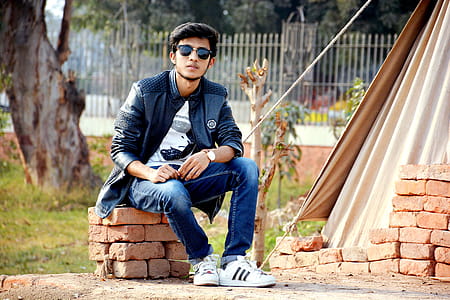 Man Wearing Sunglasses Sitting on the Concrete Bricks thumbnail