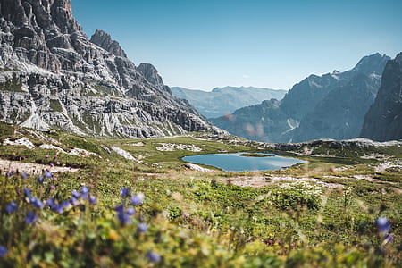 landscape photography of body of water between mountains thumbnail