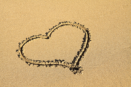photo of white sand with heart shape sand art thumbnail