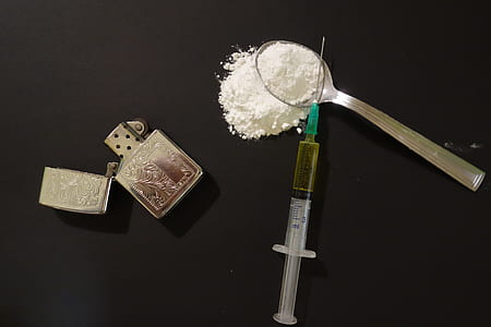 clear syringe beside silver flip lighter thumbnail