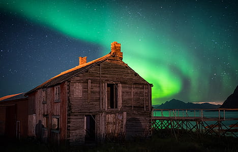 brown wooden house under green sky thumbnail