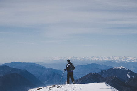 man holding ski pole on hill thumbnail