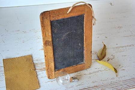 Brown Rectangular Wooden Picture Frame Near Light Bulb thumbnail