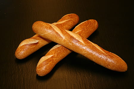 three baguettes on brown wooden surface thumbnail