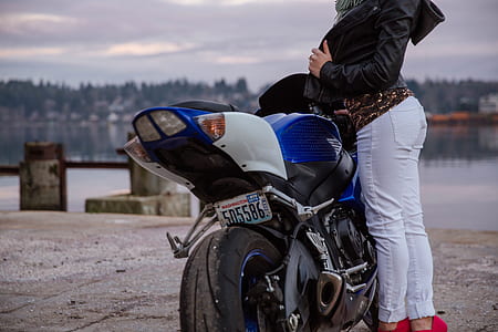 woman beside blue sports bike thumbnail
