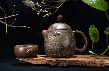 brown floral tea pot and bowl near green leaf plant thumbnail