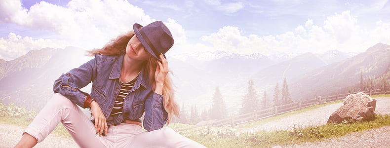woman wearing trilby hat near pine trees thumbnail