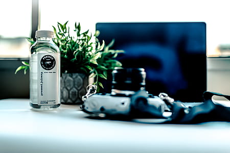 selective focus photo of bottle near monitor thumbnail