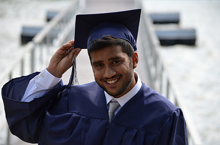 selective focus photography of man wearing blue academic gown closeup photo thumbnail