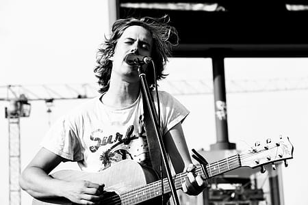 Grayscale Photo of Man Playing Guitar thumbnail