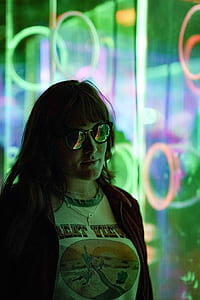 woman standing near lighted glass store faade thumbnail