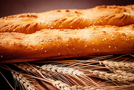 close-up photo of baked long bread with sesame seeds on top of whet thumbnail