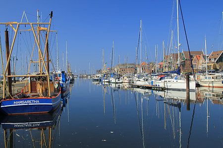 boats on body of water under blue sky thumbnail
