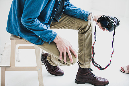 person holding camera while sitting thumbnail