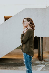 photo of woman standing beside staircase thumbnail