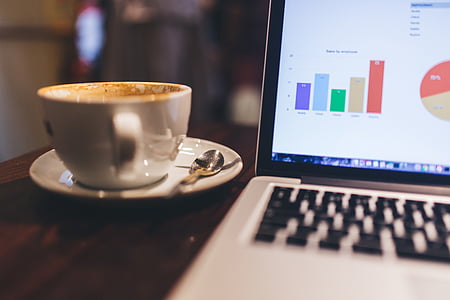 white teacup on saucer beside laptop thumbnail