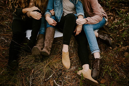 three women sitting on grass at daytime thumbnail