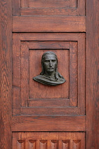man's face hanging decor on wooden door thumbnail