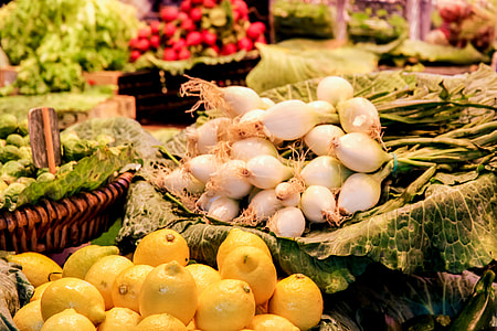 white onions near yellow round fruits photo thumbnail