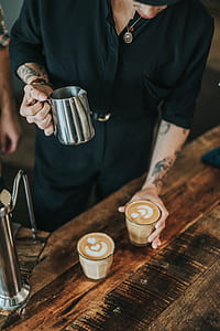 person holding silver milk pitcher thumbnail