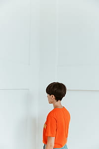 woman standing beside wall thumbnail