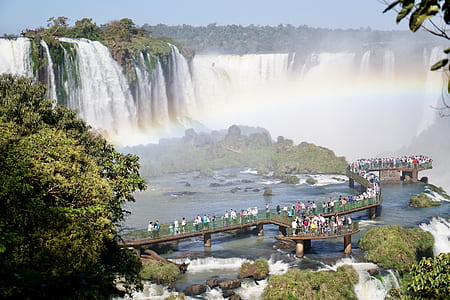 people standing on dock facing forward on waterfall taken during daytime thumbnail