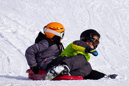 boy and girl on red sled thumbnail
