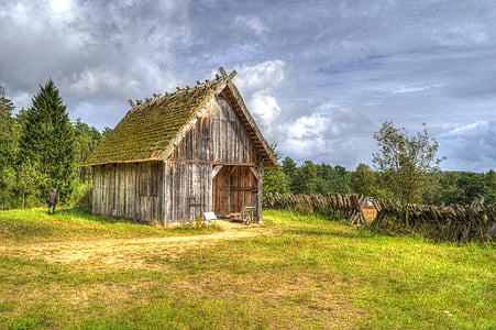 barn in the middle of the field surrounded by trees thumbnail