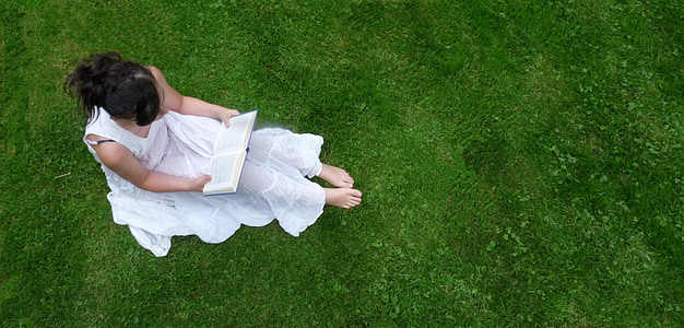 woman in white dress sitting on green gradd thumbnail