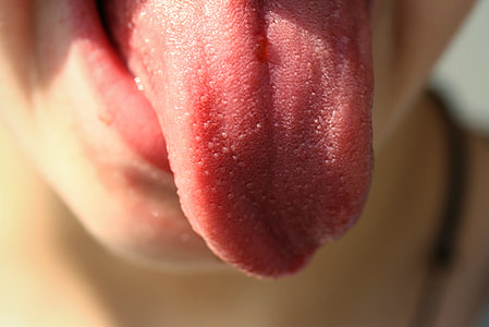 selective focus photography of person sticking tongue out thumbnail