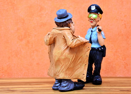 police woman checking on man in brown coat figurines thumbnail