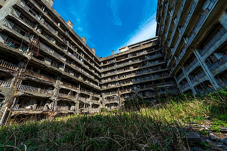 gray and brown concrete building under clear blue sky during daytime thumbnail