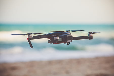 close-up photography of quadcopter flying during daytime thumbnail